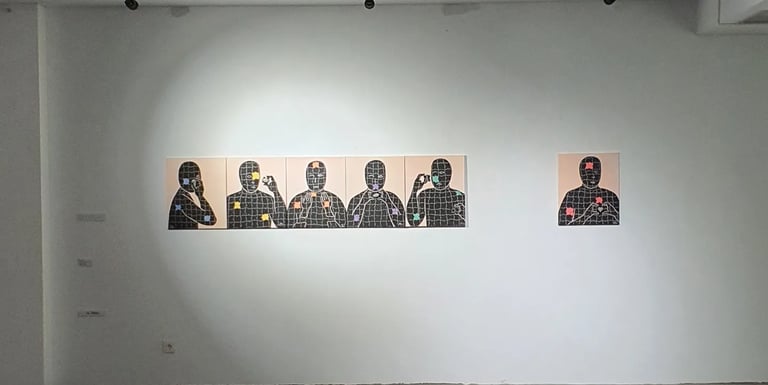 a room with a wall with three paintings on it