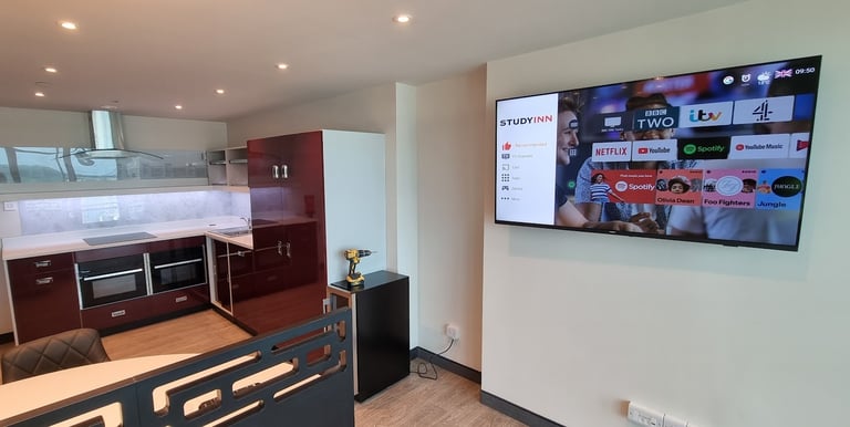 MountMyTV - Samsung 65" TV mounted on a wall in a university communal area