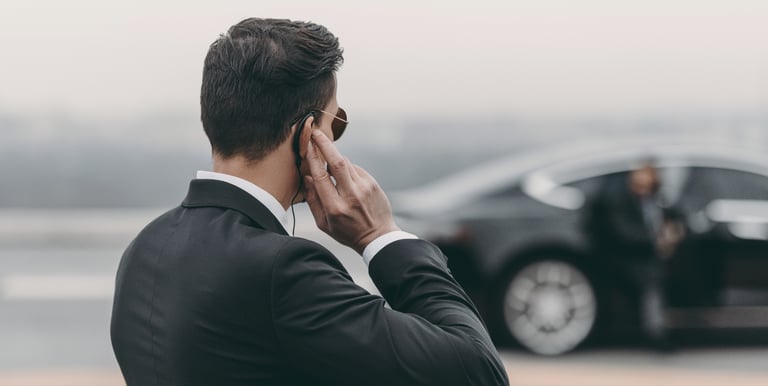 a man in a suit and tie is talking on the phone