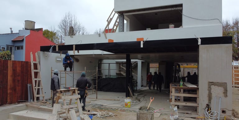 a man standing in front of a house with a roof