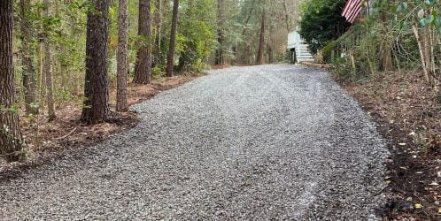 gravel driveway on a wooded lot