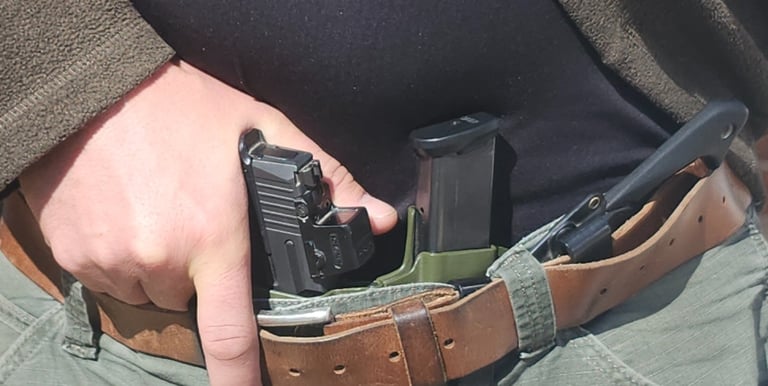 Man grips defensive firearm from concealment.