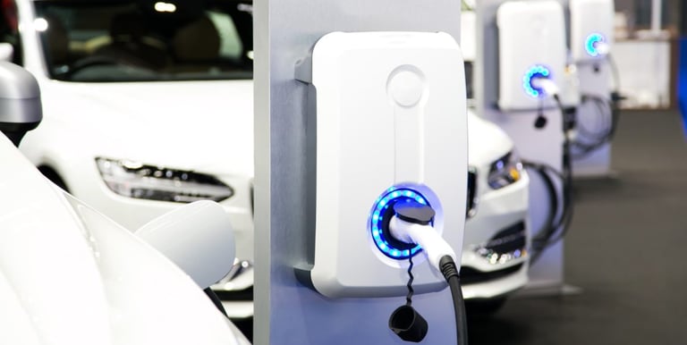 a row of electric cars parked in a row