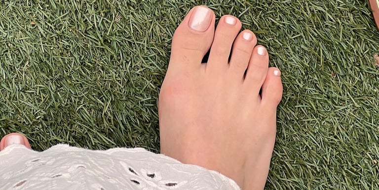 a person's feet and a pair of sandals