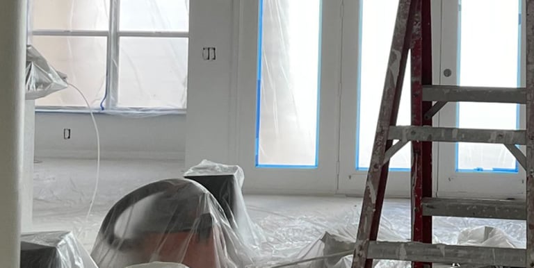 a man is painting a wall in a room