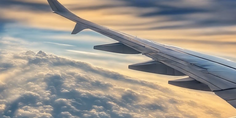 a view of the wing of an airplane as it flies over a mountain range