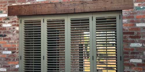 operable louver shutters with the louvers open to let light in