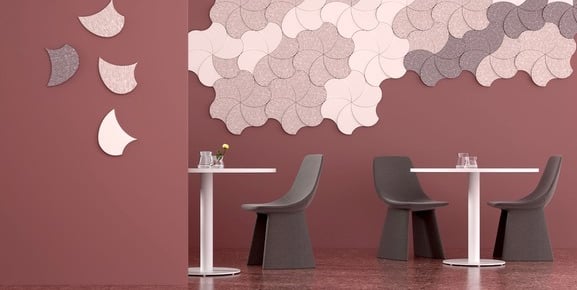 Modern decorative acoustic wall panels in a floral pattern for sound insulation in a cafe interior.