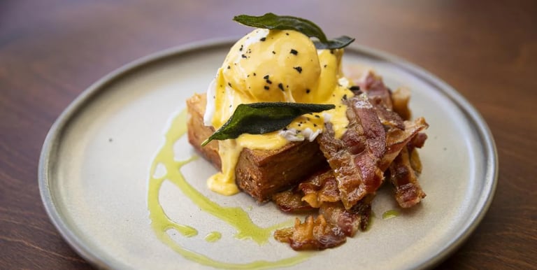 a plate of food with eggs and bacon on it