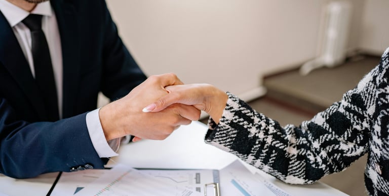 a man and woman shaking hands in a meeting