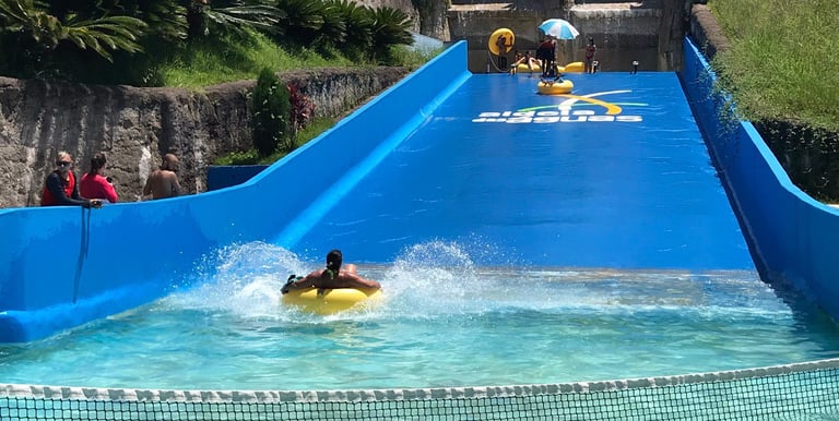 a person on a surfboard in a pool