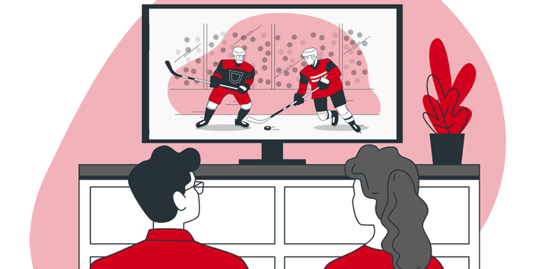 a couple sitting on a couch watching streaming sports game on their large screen TV