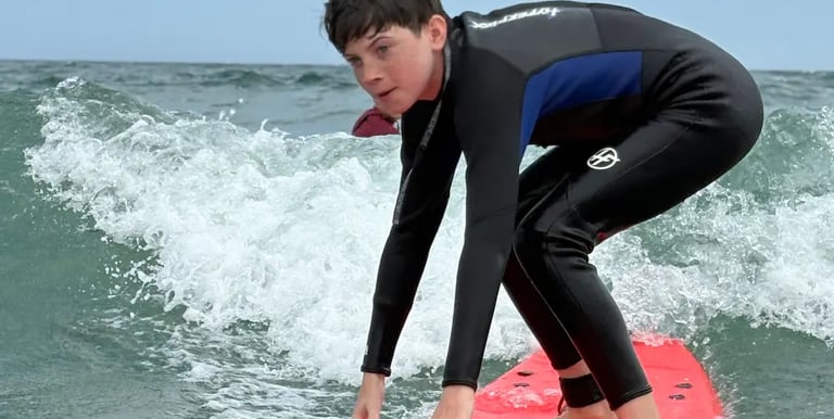 Teen boy surfing at north of Jenness Beach in Rye NH