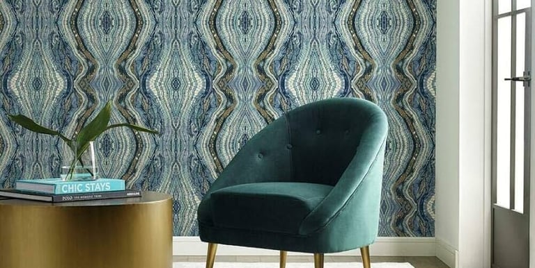 Modern living room featuring blue marbled wallpaper and a teal velvet accent chair.