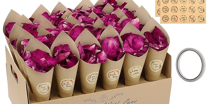 a box of pink rose petals on a table