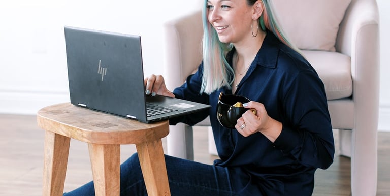 Tabitha with butterfly effect consulting on her laptop talking to a client