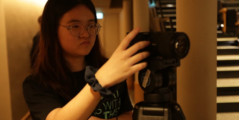 NAPC student photographer mounting camera on a tripod