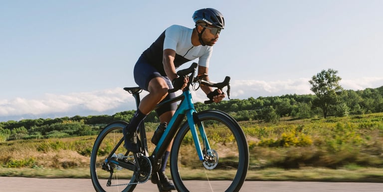 a man riding a bicycle on a road