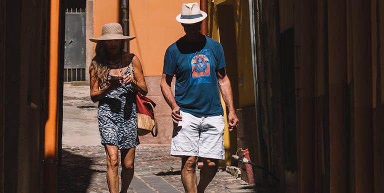 Tourists walking through narrow alleys in Bosa, Sardinia