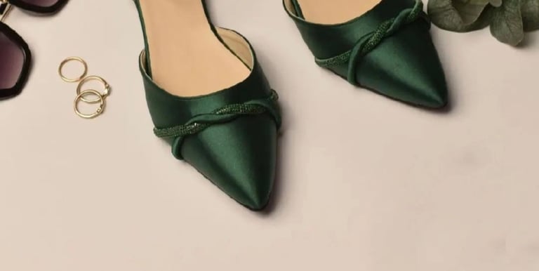 a pair of green shoes and sunglasses on a table