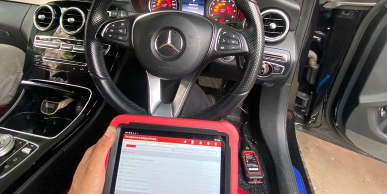 a person sitting in a car with a tablet and a tablet