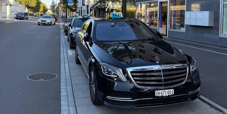 Black Mercedes S-Class parked in a row with two Mercedes E-Classes