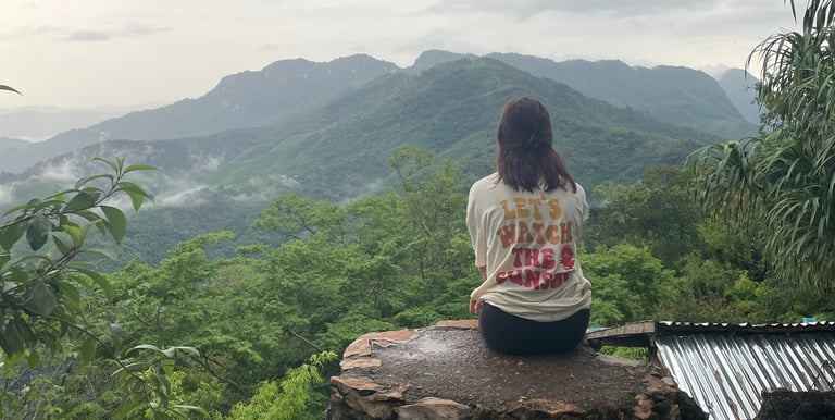 Girl on mountain watching the view at Ngoi