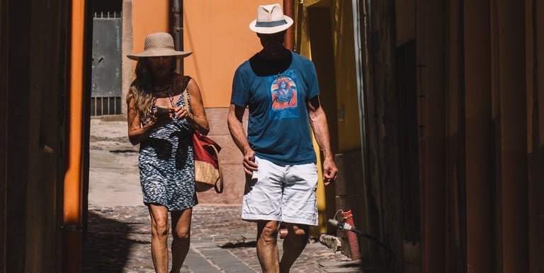 Tourists walking through narrow alleys in Bosa, Sardinia