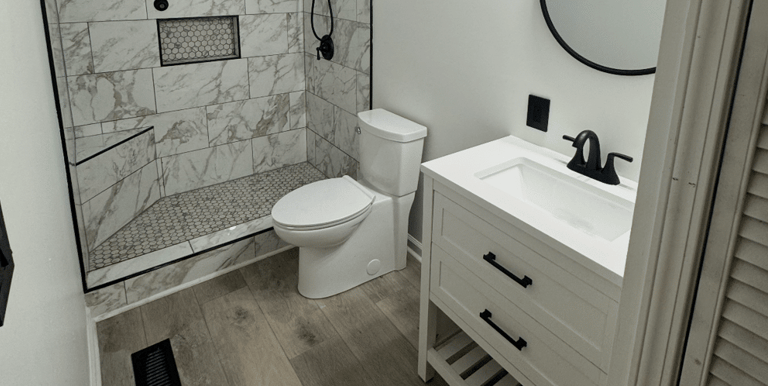 a bathroom with a marble shower and a marble shower