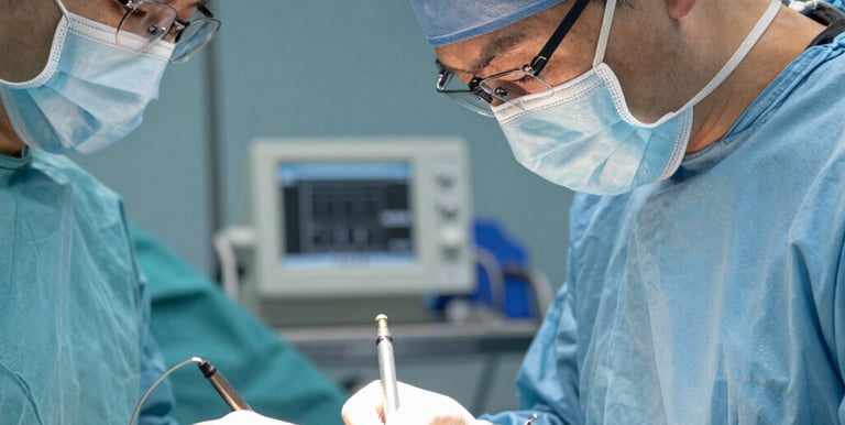 Close-up of a patient’s hand being carefully wrapped with a supportive bandage.