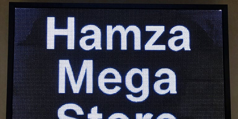 Close-up of vibrant flex printing on a glossy banner under warm lighting.