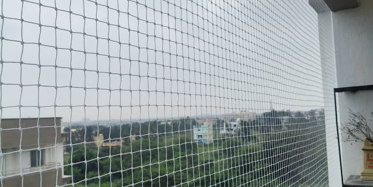 Technician carefully measuring a balcony for safety net installation.