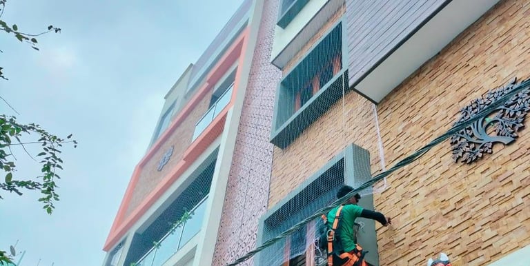 A close-up of a well-installed balcony safety net on a residential building in Nungabakkam.