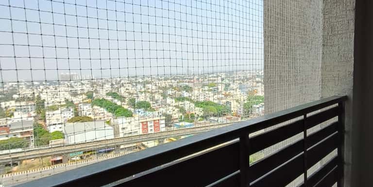 A family enjoying their balcony safely protected by a durable safety net.