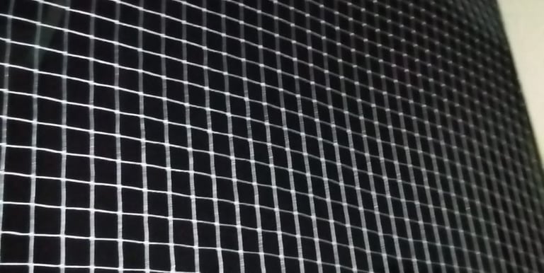 A close-up of a securely installed balcony safety net on a residential building in Adyar.