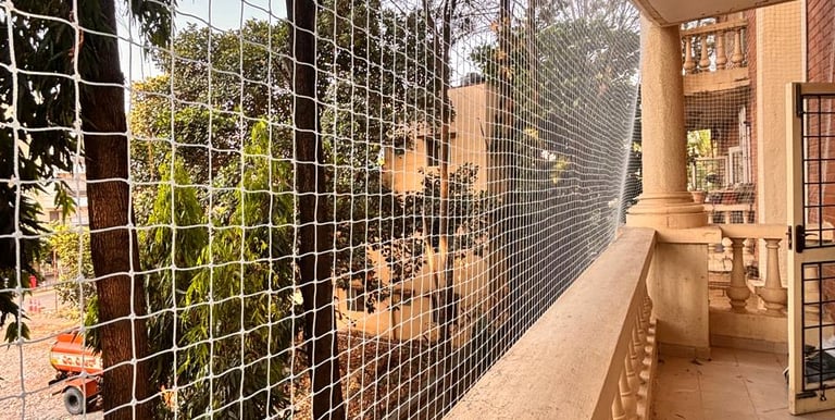 Close-up of a securely installed balcony safety net protecting a family home.