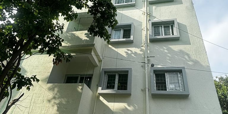 Technician from Arjilli Enterprises fitting safety nets on an apartment duct.