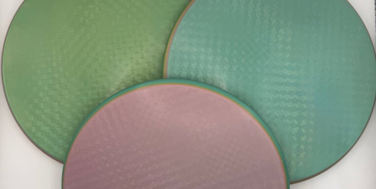 Three circular textured silicone baking mats in green, teal, and pink colors.