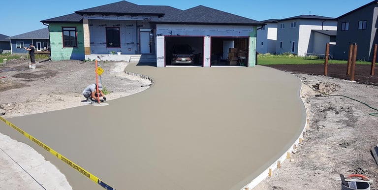 finishing touches on a driveway before brooming