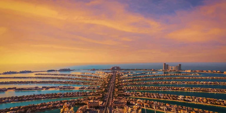 Aerial view of Palm Jumeirah featuring luxury villas and private beachfront residences, representing exclusive real estate in