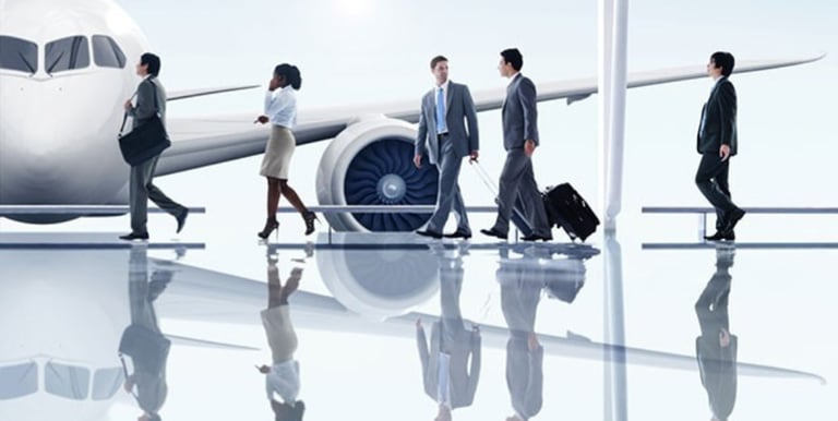 a group of business people walking through a airport