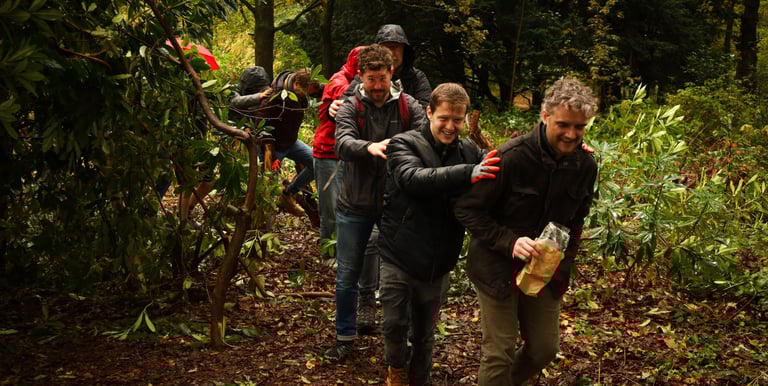 a team walking in the forest with Dorchess and Awe Academy