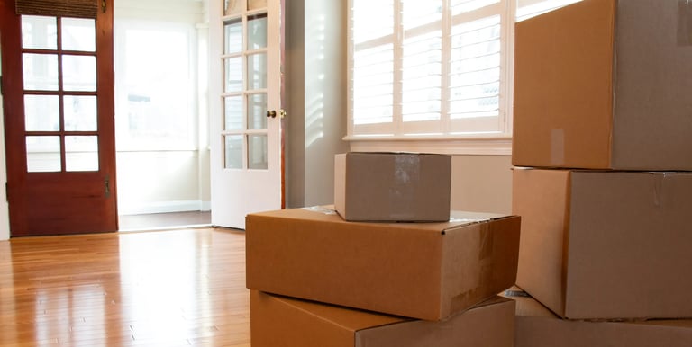 an empty room with moving boxes