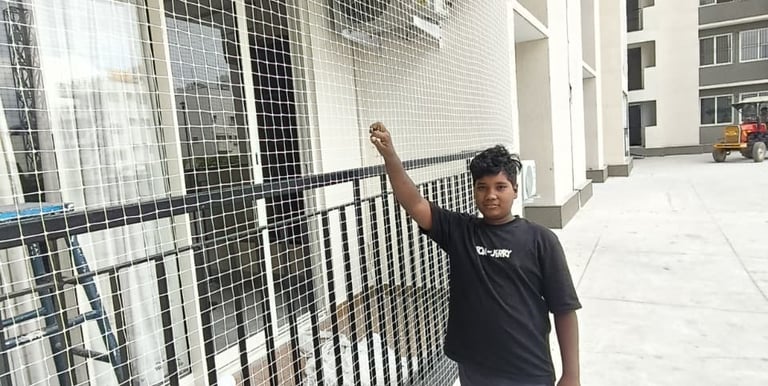 Close-up of a securely installed balcony safety net protecting a child playing nearby.