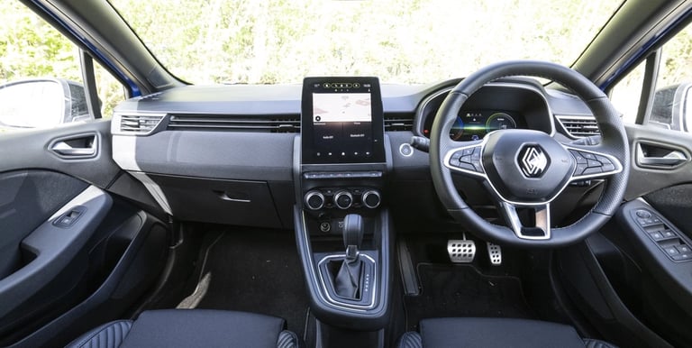 a car dashboard with a steering wheel and steering wheel