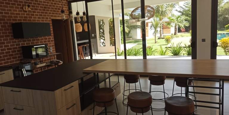 a kitchen with a bar stool and bar stools