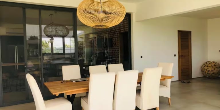a dining room table with chairs and a chandelier