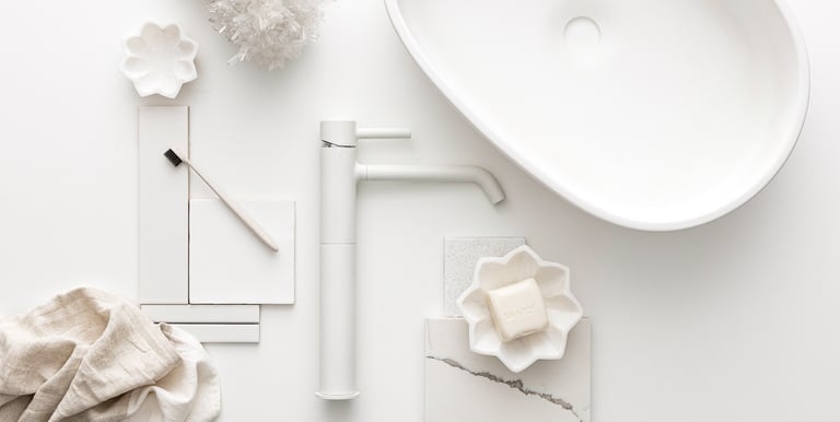 Product photography - a sink with a tap and tiles styled on a white table