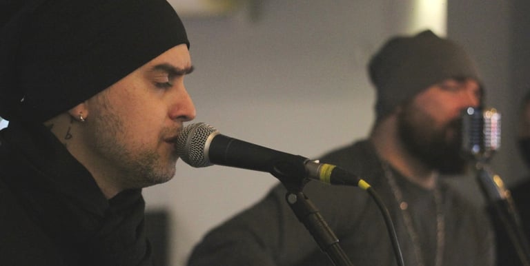 a man with a beard and a beard playing guitar