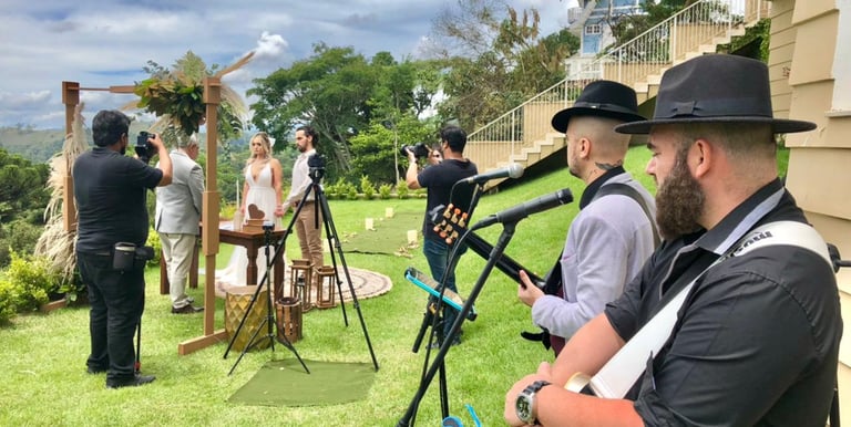 a man in a hat and a guitar playing a song